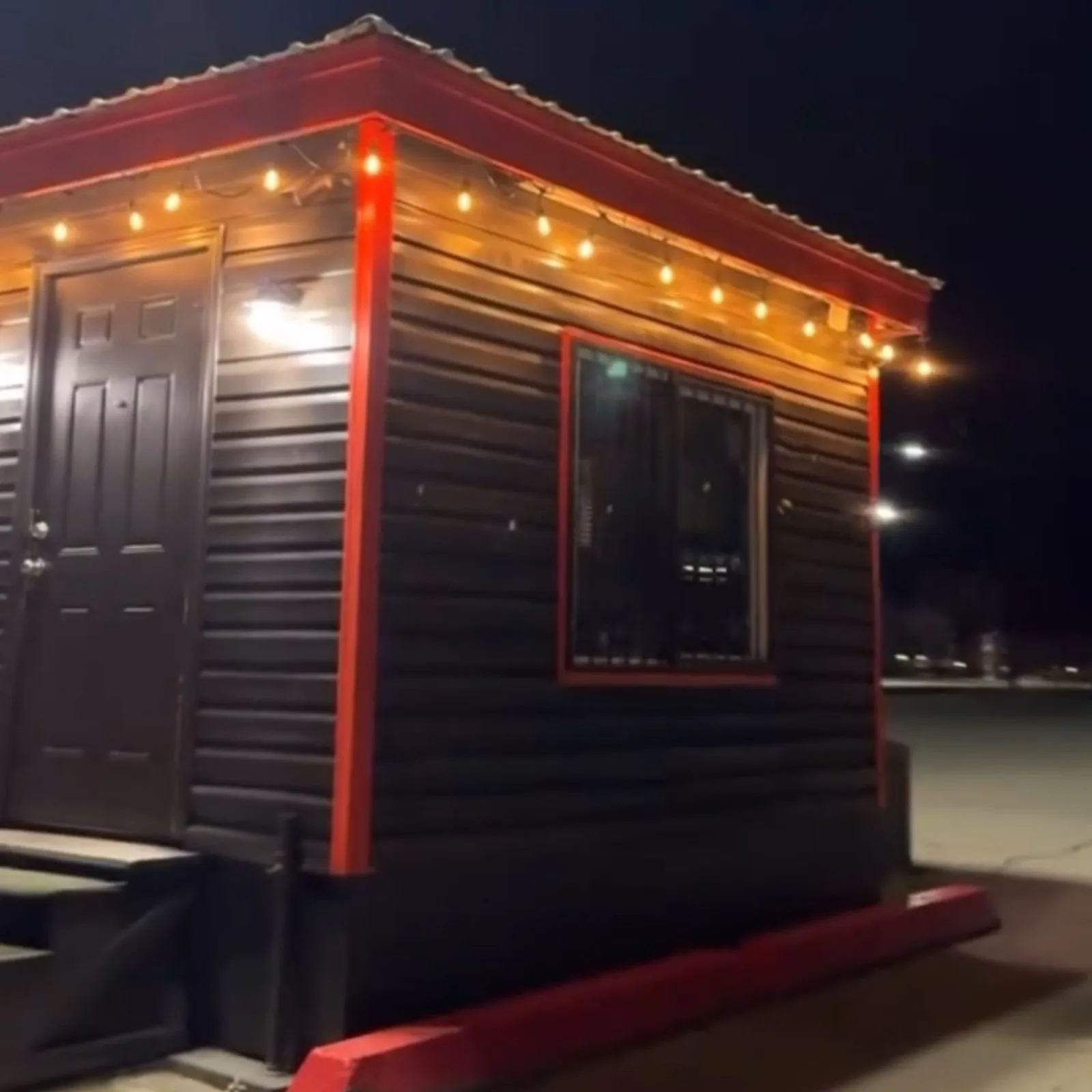 The VV's hut at night under string lights